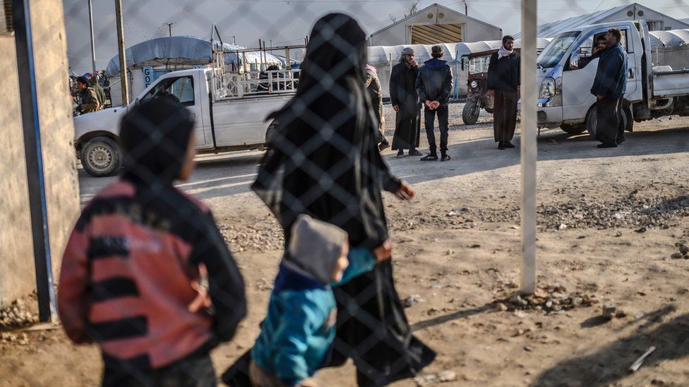 One of the two detained French women who fled the Islamic State group"s last pocket in Syria walks with her child after speaking to a AFP reporter at al-Hol camp in the al-Hasakeh governorate in northeastern Syria on February 17, 2019.