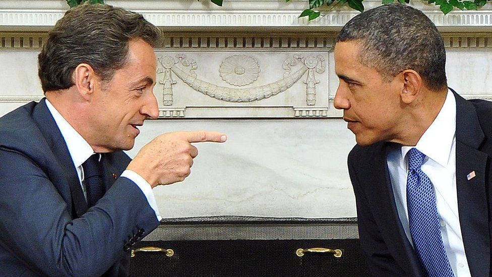 Barack Obama listens to his French counterpart Nicolas Sarkozy during a meeting in the Oval Office at the White House on January 10, 2011