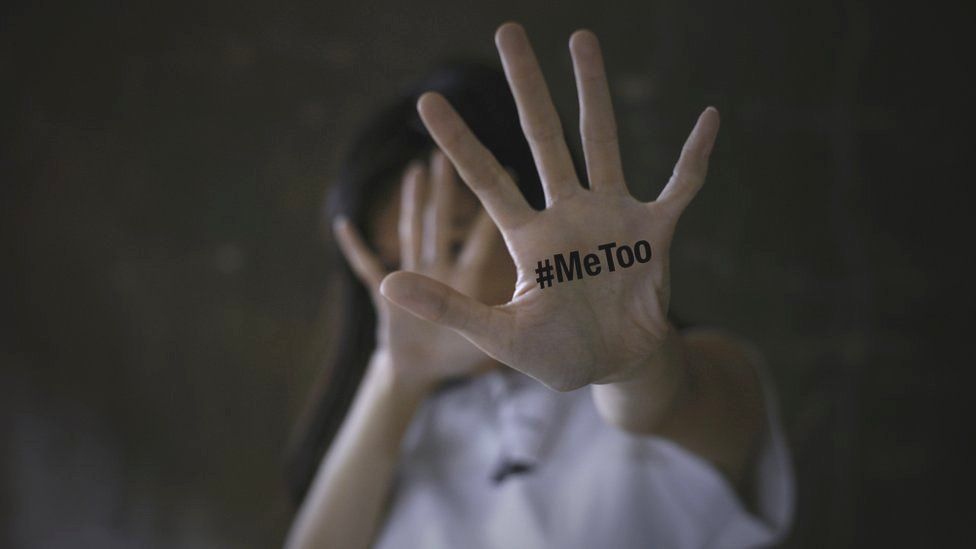 A woman showing her hand with the MeToo slogan