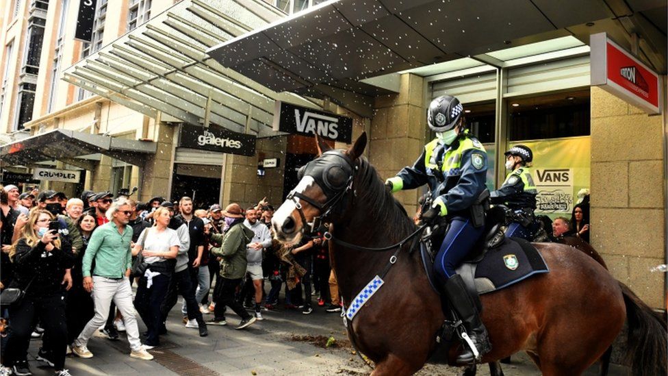 Anti-lockdown protesters throw objects at mounted police in Sydney