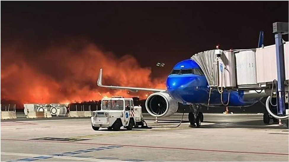 Wildfire burns near airport tarmac