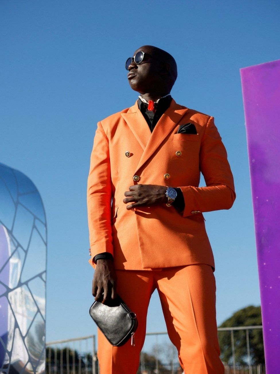 A model poses in an orange suit.