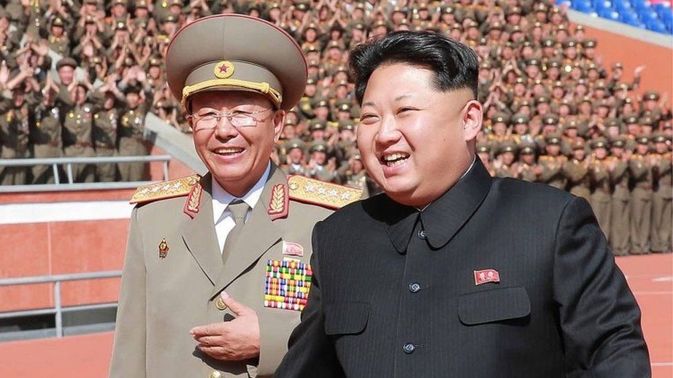 File photo of Gen Ri (left) and leader Kim Jong-un from North Korean media