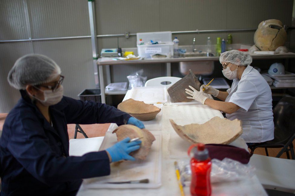 Researchers clean artefacts found amid the debris