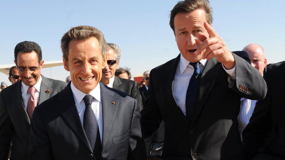 Former French president Nicolas Sarkozy and David Cameron arrive at Benghazi airport in 2011