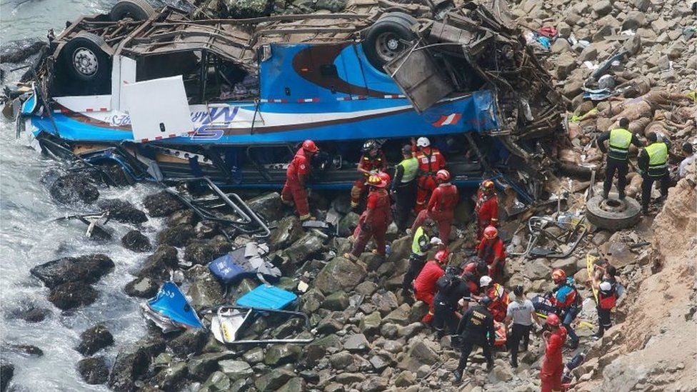 1 A handout photo made available by Agencia Andina shows a group of emergency personnel working to rescue victims after a passenger bus plunged off the Pan-American Highway North, about 45 kilometers from Lima, Peru, 02 January 2018.