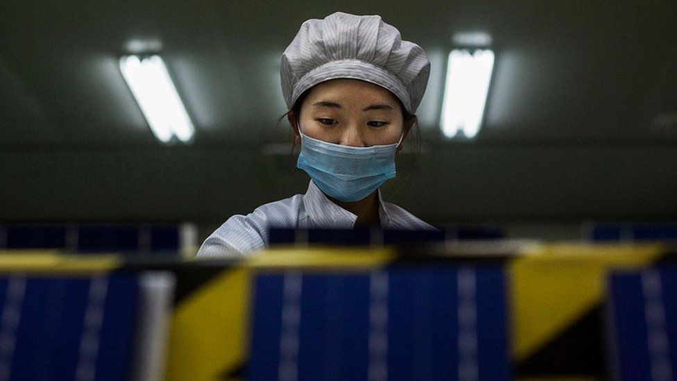 A technician from Yingli Solar prepares solar cells used for solar panels at the company's headquarters, in Baoding, Hebei Province