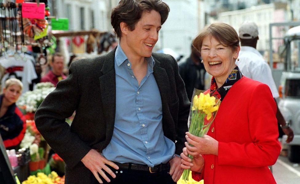 File photo dated 04/05/98 of Hugh Grant with Glenda Jackson, (then) Minister of Transport for London, during a visit to the set of his film on location in Notting Hill, west London