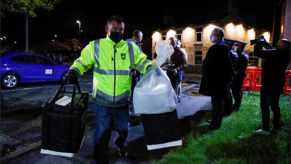 A member of the elections commission carries bags with ballots at Mill House Leisure Centre, in Hartlepool,