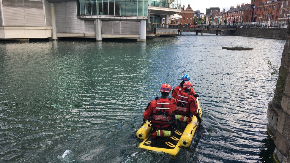 Humberside Fire and Rescue Service crew in an inflatable raft on water