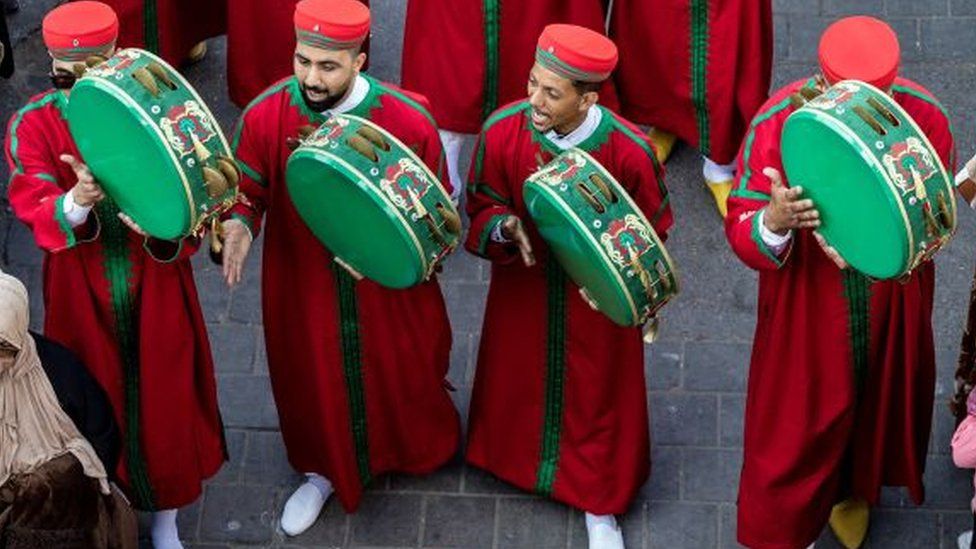 Members of traditional Gnawa bands and dancers take part in a parade on the streets during the opening ceremony of the 24th edition of the Gnaoua World Music Festival in Essaouira on June 22, 2023