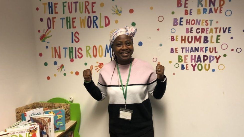 Founder Funmilayo Akinriboya in the library, with some quotes on the wall behind her