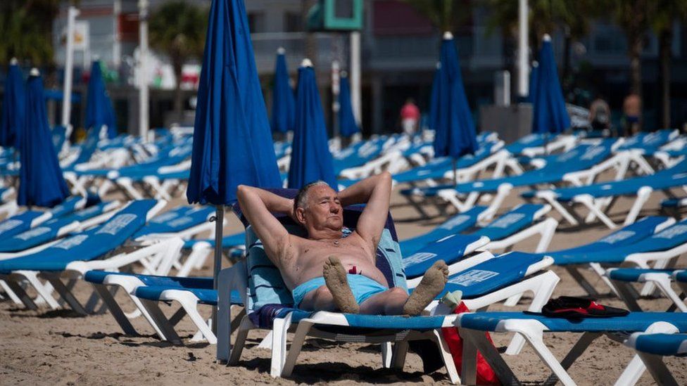 A man sunbathes in Benidorm