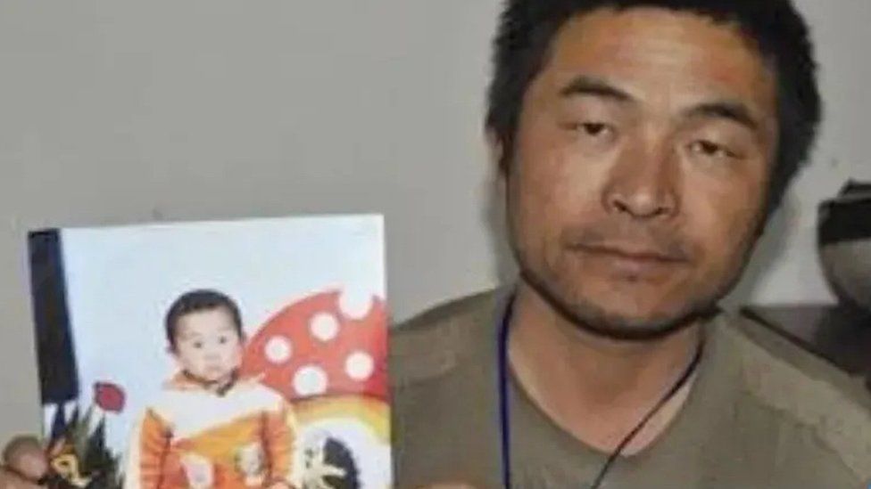 Guo Gangtang and a picture of his missing son
