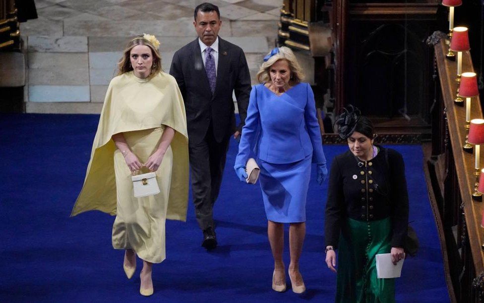 US First Lady Jill Biden arrives astatine  Westminster Abbey wearing bluish  with her granddaughter Finnegan successful  yellow