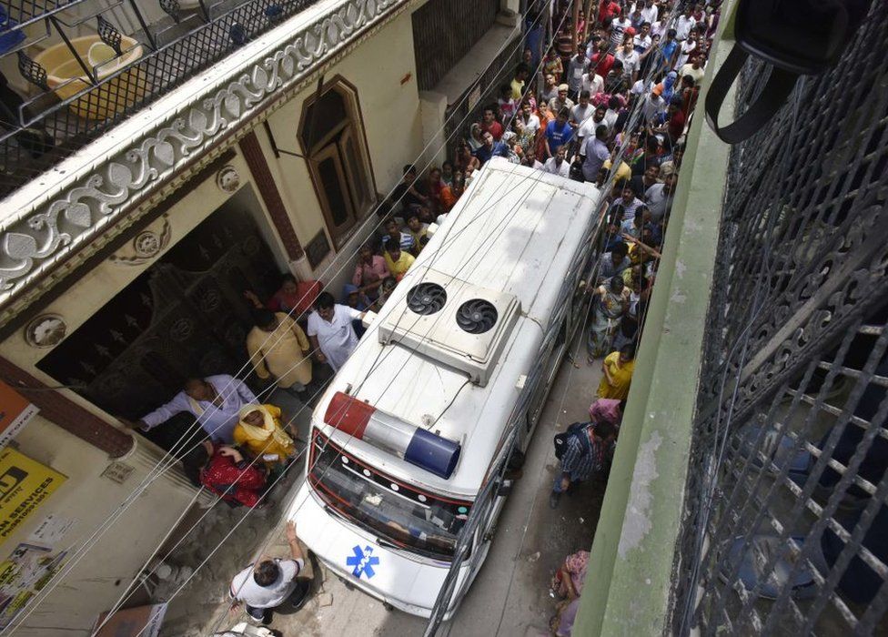 An ambulance is seen outside the home of the Bhatias.