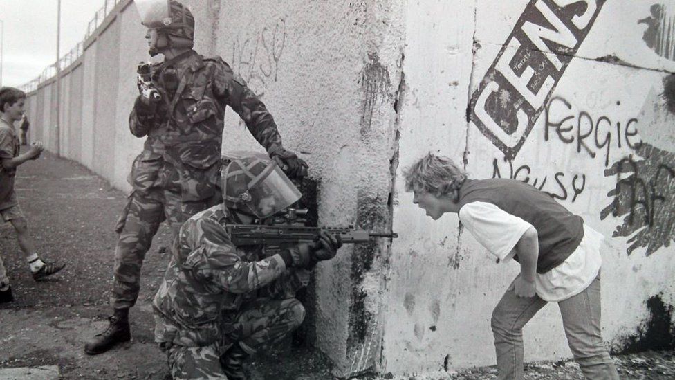 A woman has an argument with soldiers at Whiterock in Belfast