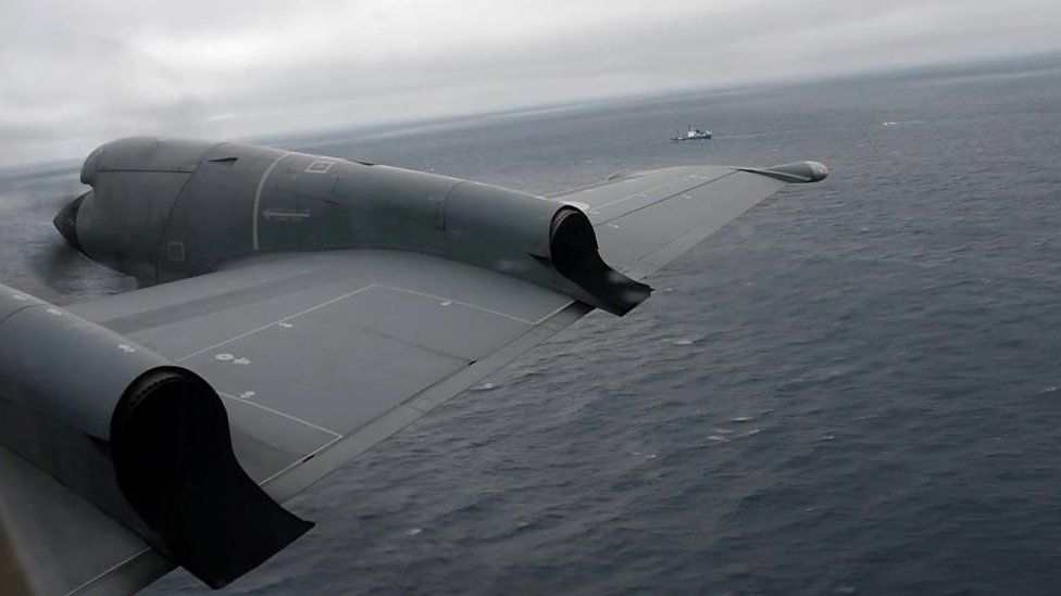 A Royal Canadian Air Force CP-140 Aurora maritime surveillance craft  of 14 Wing flies a hunt  signifier   for the missing OceanGate submersible