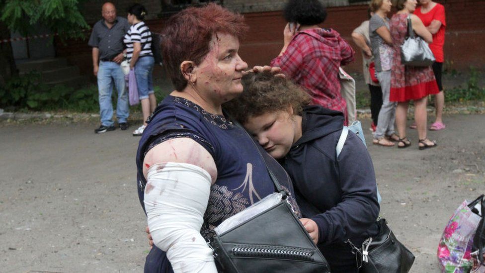 A mother and daughter comfort one another