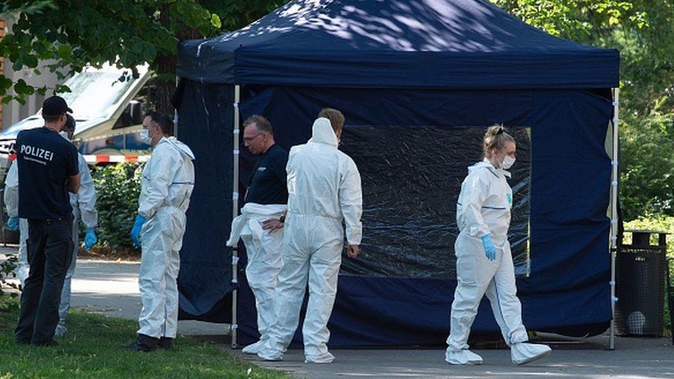 Forensic experts secure evidence at the site of a crime scene in Berlin