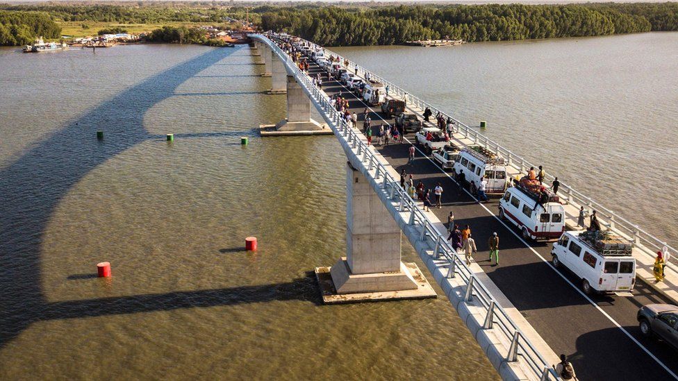 Aerial view of people crossing the Farafenni Bridge after its inauguration by Senegal's president and Gambia's President on 21 January 2019, in Farafenni