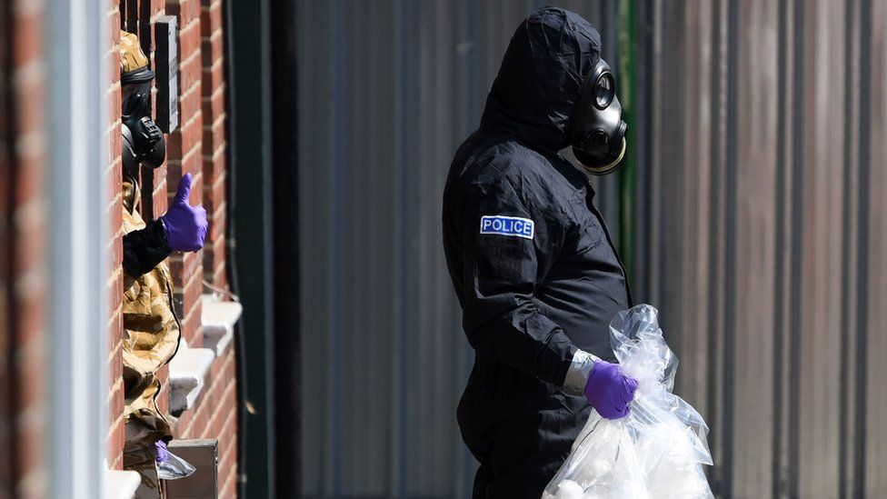 A police investigator in a protective suit in Amesbury