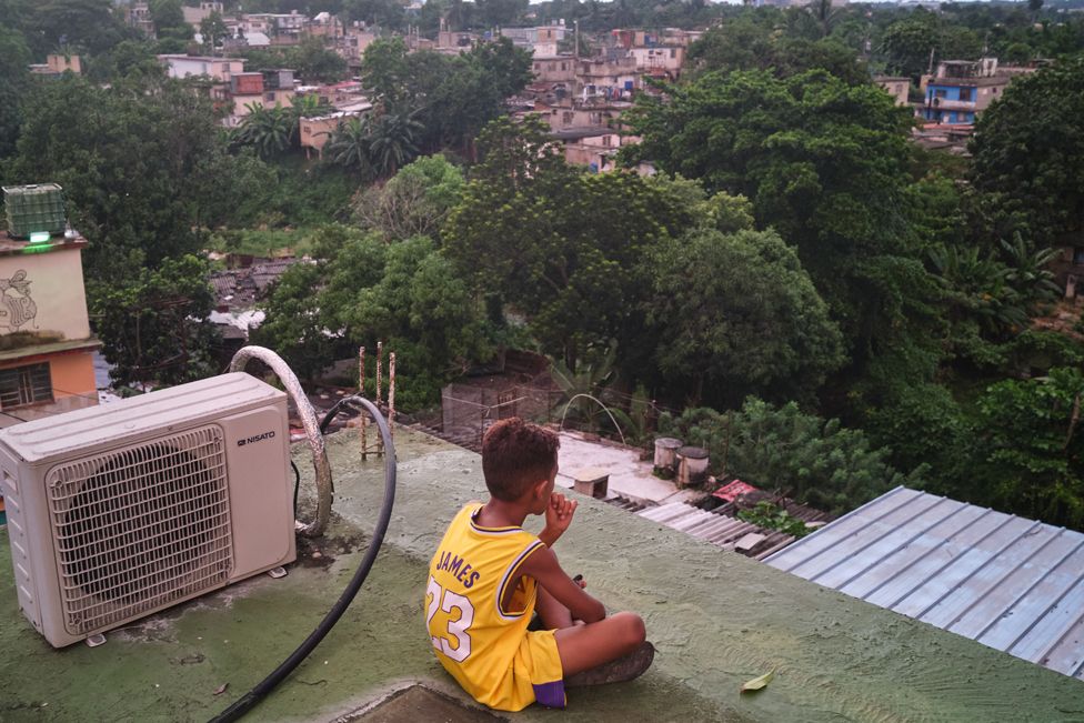 Eyko Rodríguez Lara, 9, sits on the rooftop terrace at his grandmother's house in Havana, Cuba, on September 20, 2022.