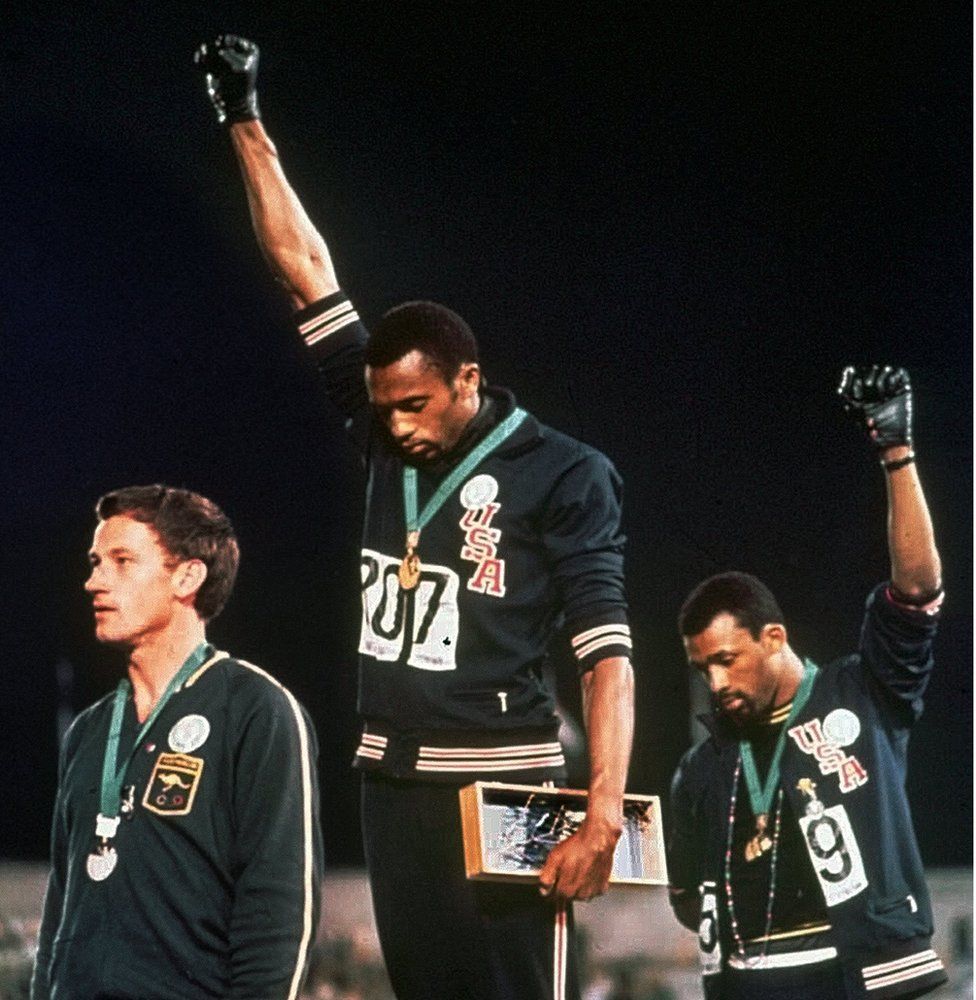 Black American athletes Tommie Smith (centre) and John Carlos