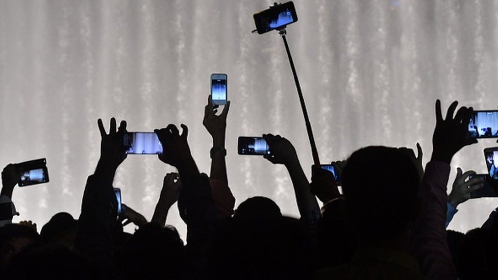 People holding up mobile phones
