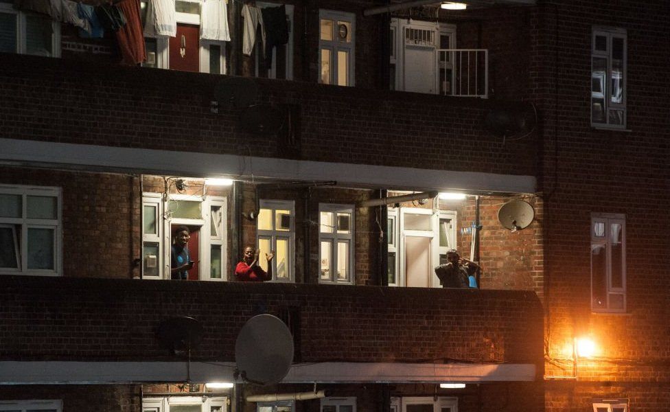 LONDON, ENGLAND - MARCH 26: Residents of the Tulse Hill Estate in South London come out onto their balconies to applaud NHS staff fighting the virus on March 26, 2020 in London, England.