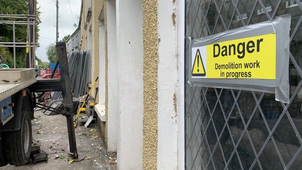 Sign saying "Danger: demolition work in progress"