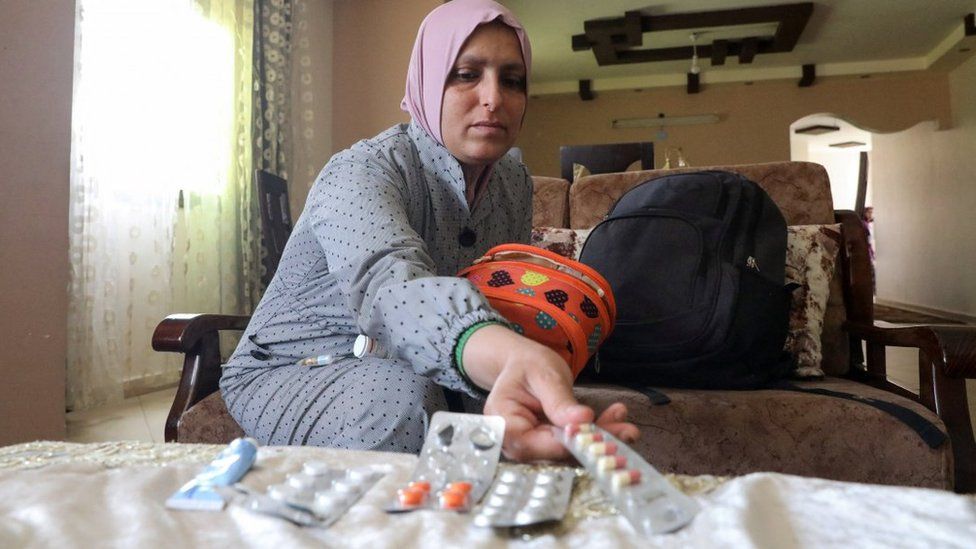 Dina el-Dhani, a Palestinian cancer patient in Gaza City, displays her medication. Photo: 12 May 2023