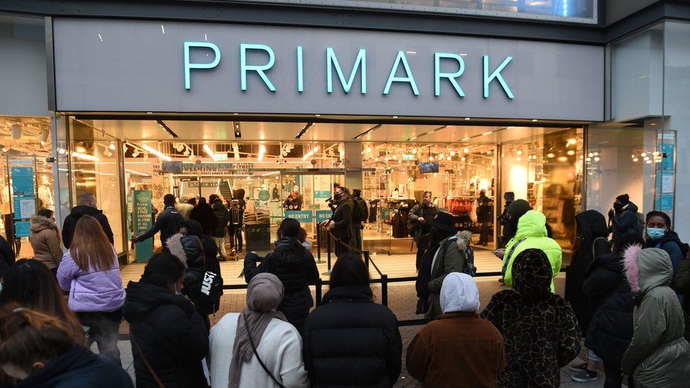 Early morning shoppers standing in line outside Primark, Birmingham