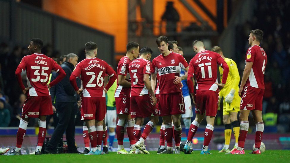 Middlesbrough players wait as play is paused due to a medical emergency in the stands