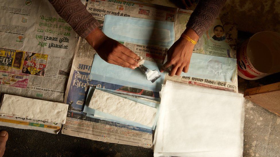 Women making sanitary pads in India
