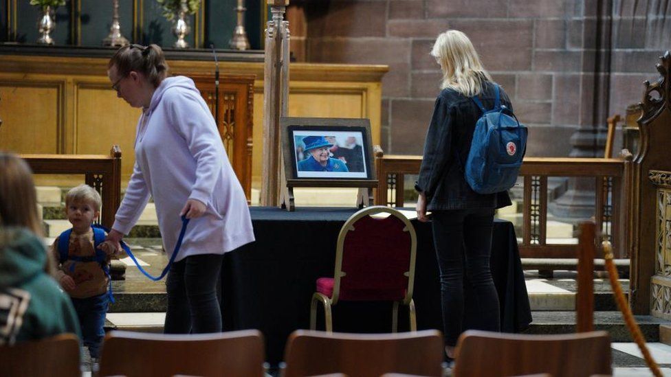 People sign a book of condolence at Liverpool Cathedral