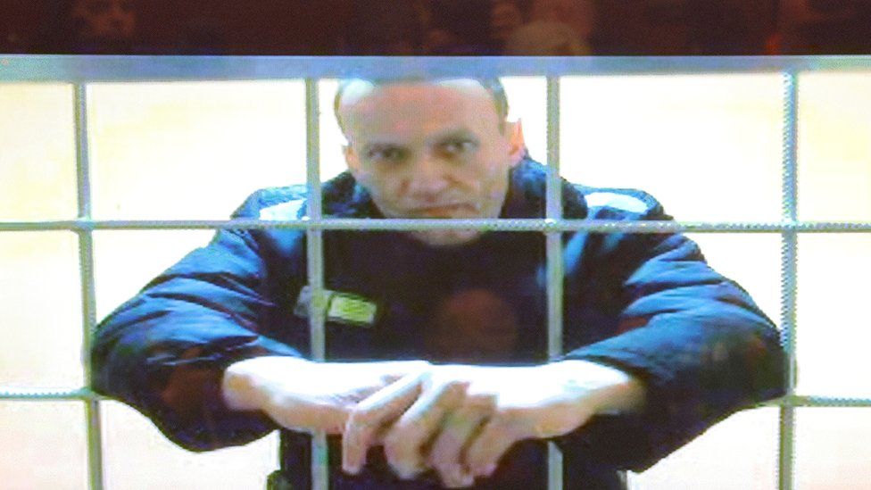 Russian opposition leader Alexei Navalny is seen on a screen via a video link from the IK-2 corrective penal colony in Pokrov during a court hearing to consider an appeal against his prison sentence in Moscow, Russia May 24, 2022