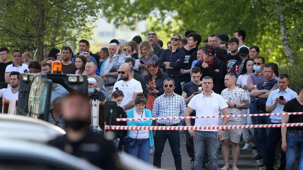 People gather at school No 175 following the attack