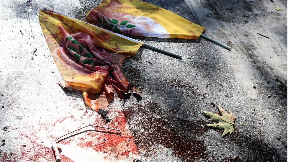Blood covered flags at the scene of the blast after explosions in Ankara, Turkey - Saturday 10 October 2015