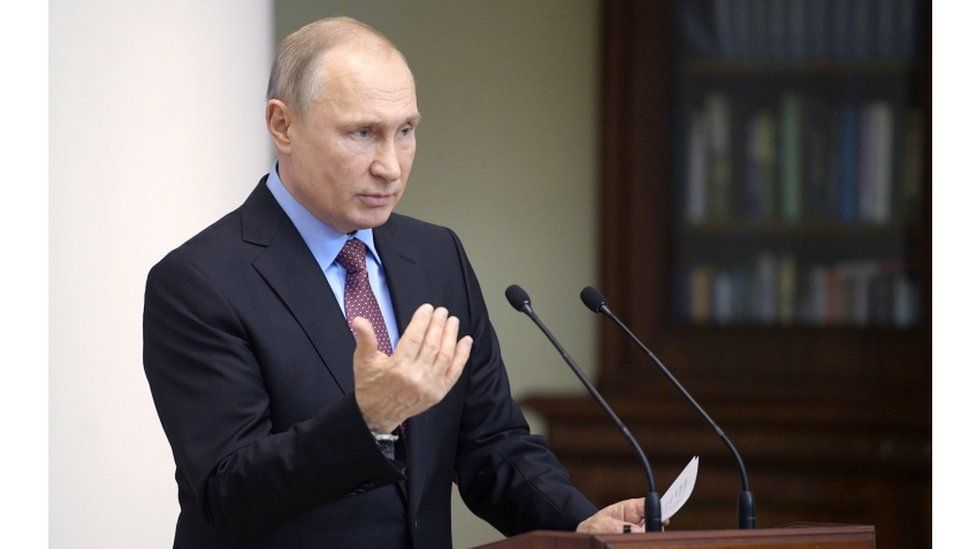 President Putin at a podium delivering the speech on his new passport policy