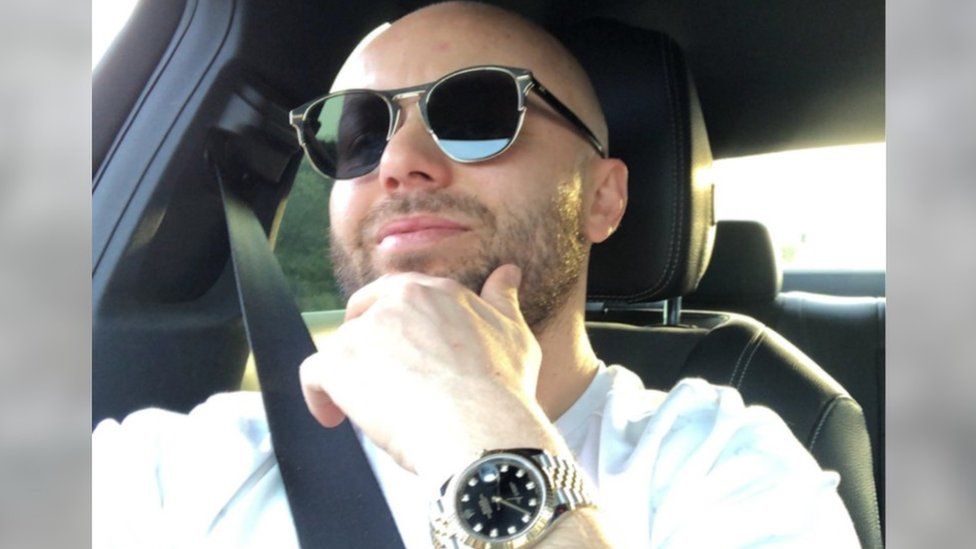 A man in sunglasses and a Rolex