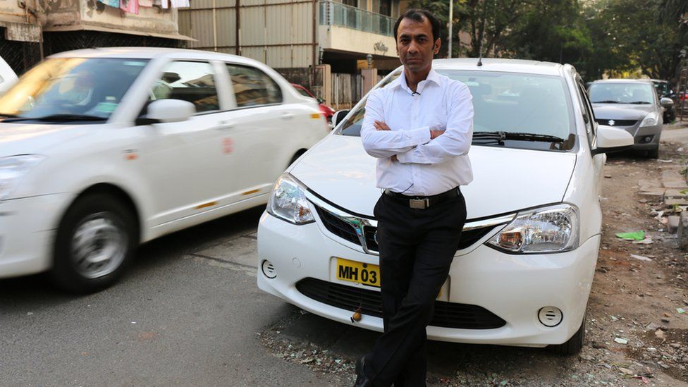 Mumbai driver Kuldeep Singh Barswal in front of his taxi