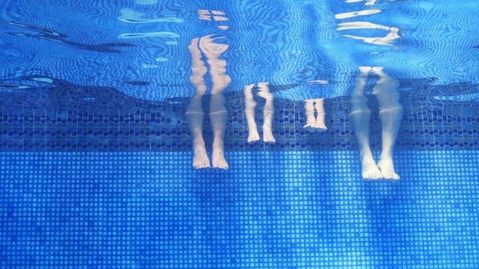 A family in a swimming pool