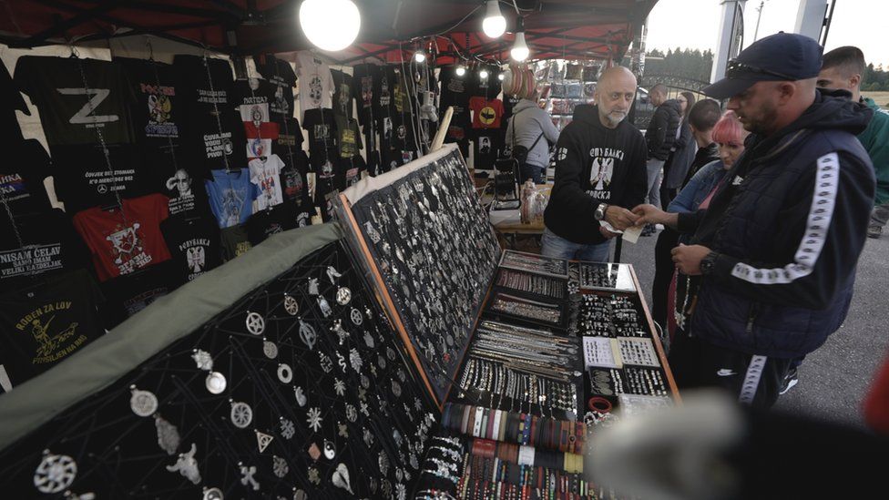 10th August 2023 - Attendees at a religious festival in the Republika Srpska purchase souvenirs, some of which revere Bosnian Serbs convicted of war crimes by The International Criminal Tribunal for the former Yugoslavia (ICTY), such as General Ratko Mladić.