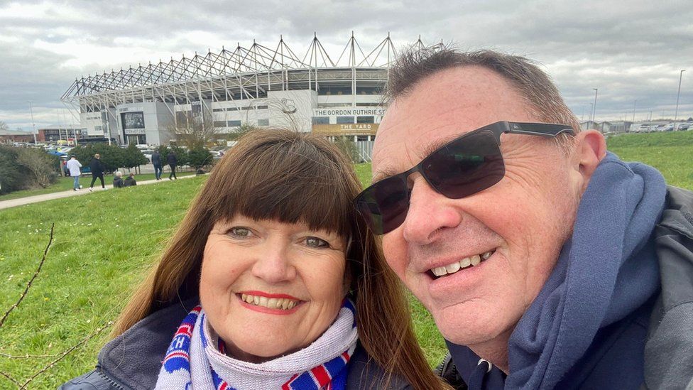 Angela Howarth and Simon Stanmore standing outside the Derby County stadium Pride Park