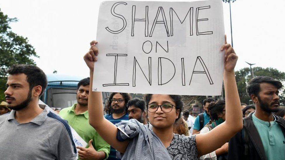 Students and activists hold placards during a protest in Bangalore