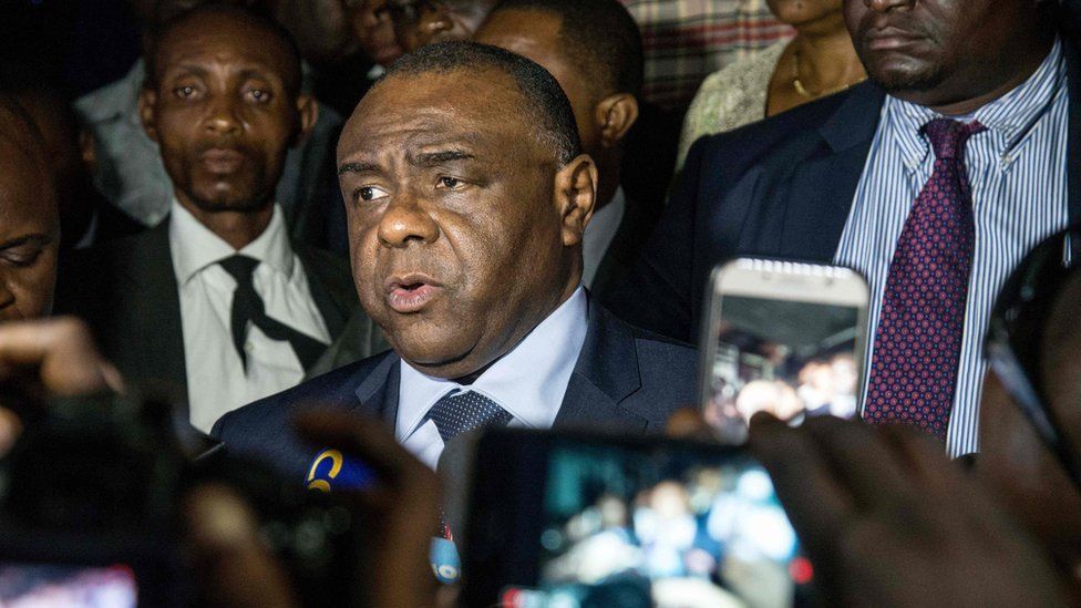Congolese opponent Jean-Pierre Bemba (C), speaks to the press after applying to be a candidate for next presidential elections of December 23
