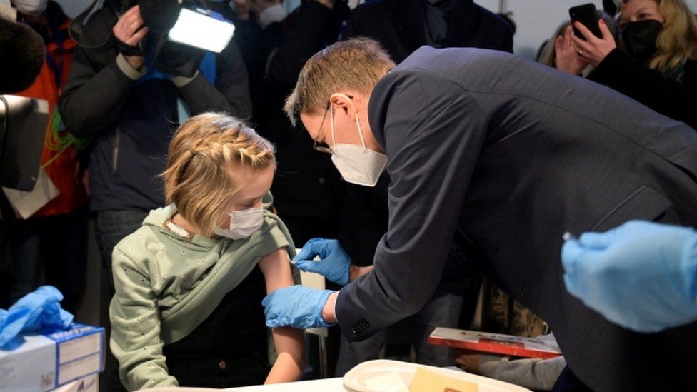 German Health Minister Karl Lauterbach vaccinates Frida during a visit to a coronavirus disease (COVID-19) vaccination centre in Hanover, Germany, December 17, 2021