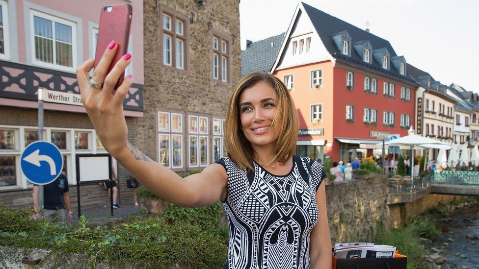 woman take picture on phone in Germany