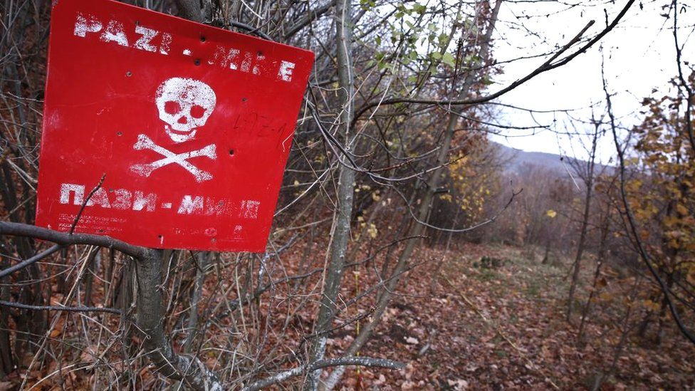A "danger of death" sign is seen at a minefield in a woodland in Sarajevo, Bosnia and Herzegovina on November 20, 2017.